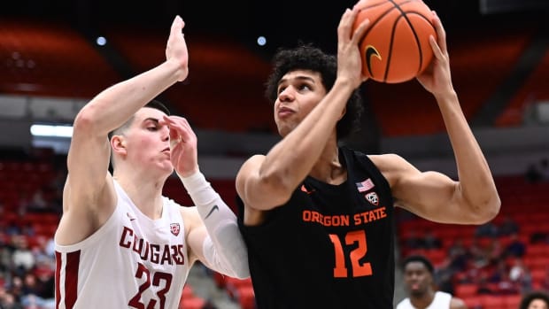 Feb 16, 2023; Pullman, Washington, USA; Oregon State Beavers forward Michael Rataj (12) shoots the ball against Washington State Cougars forward Andrej Jakimovski (23) in the second half at Friel Court at Beasley Coliseum. Washington State won 80-62. Mandatory Credit: James Snook-USA TODAY Sports